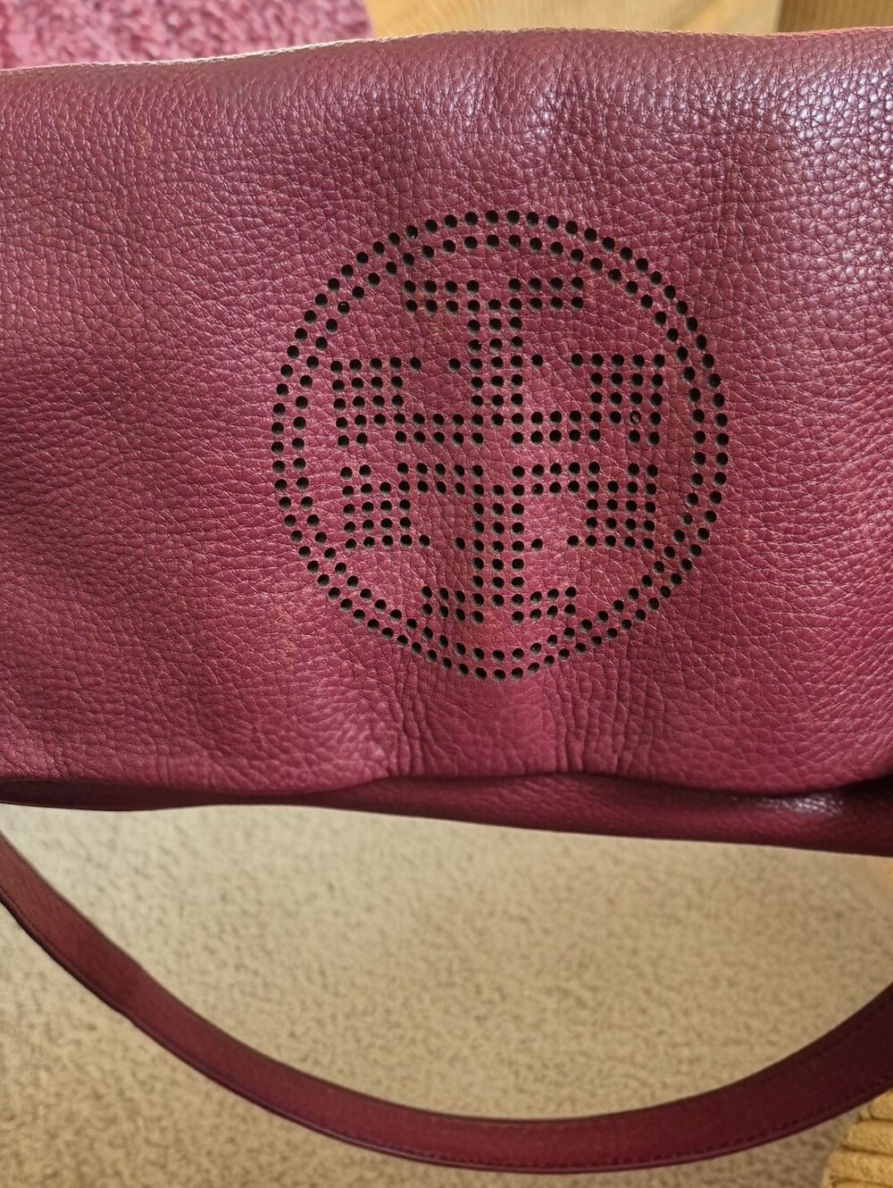 Tory Burch foldover crossbody bag featuring a perforated double-T logo